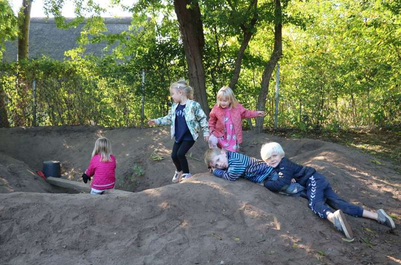 Børn i leg i bakket terræn